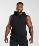 رجل يرتدي هودي Legacy Drop Arm باللون الأسود بدون أكمام من Gymshark | United We Sweat، يعرض تصميمًا معاصرًا.